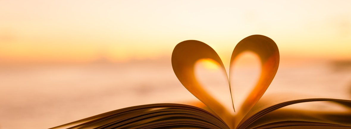 Book with centre pages curled to make a heart.